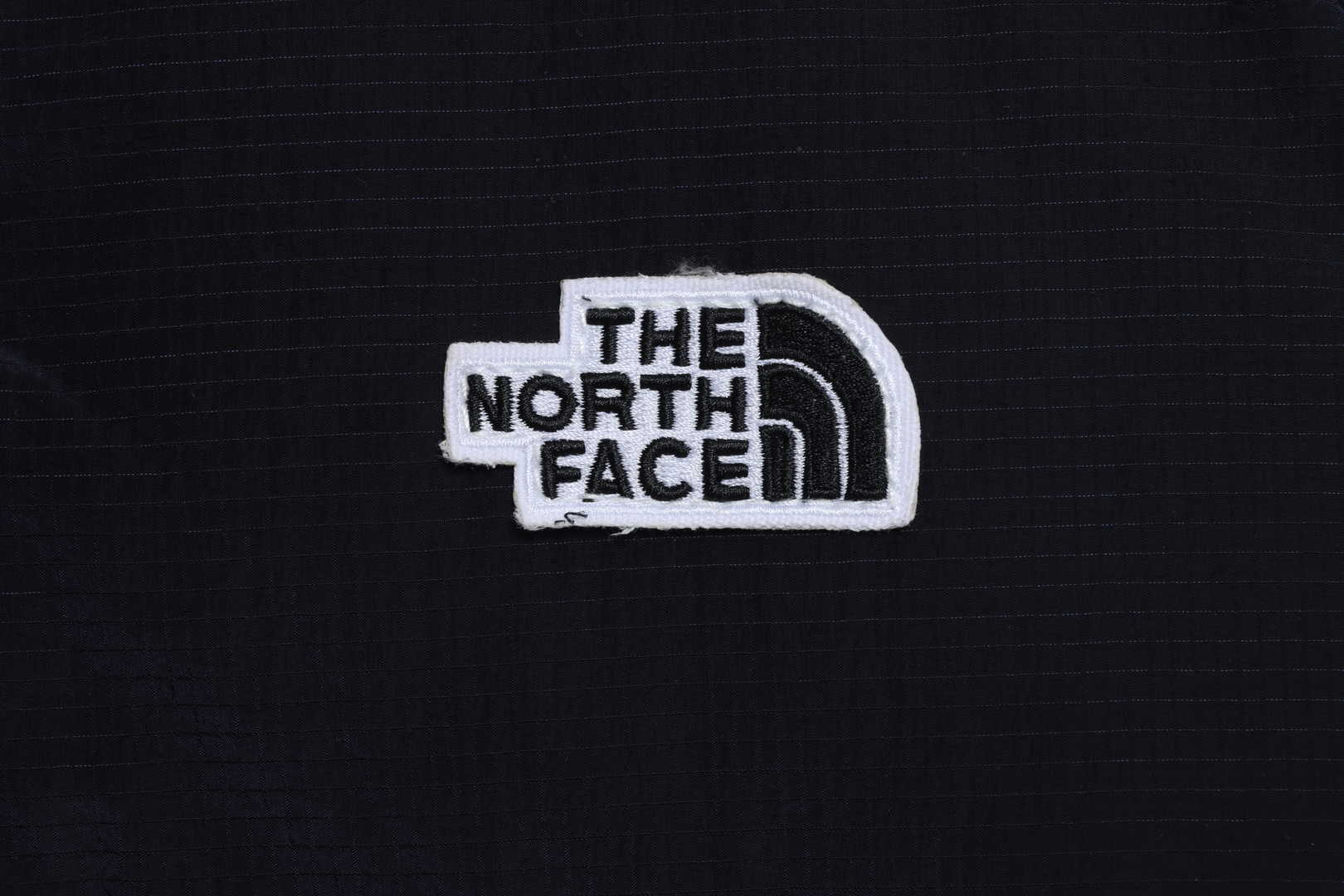 the n0*h F**e chest patch micro label down vest