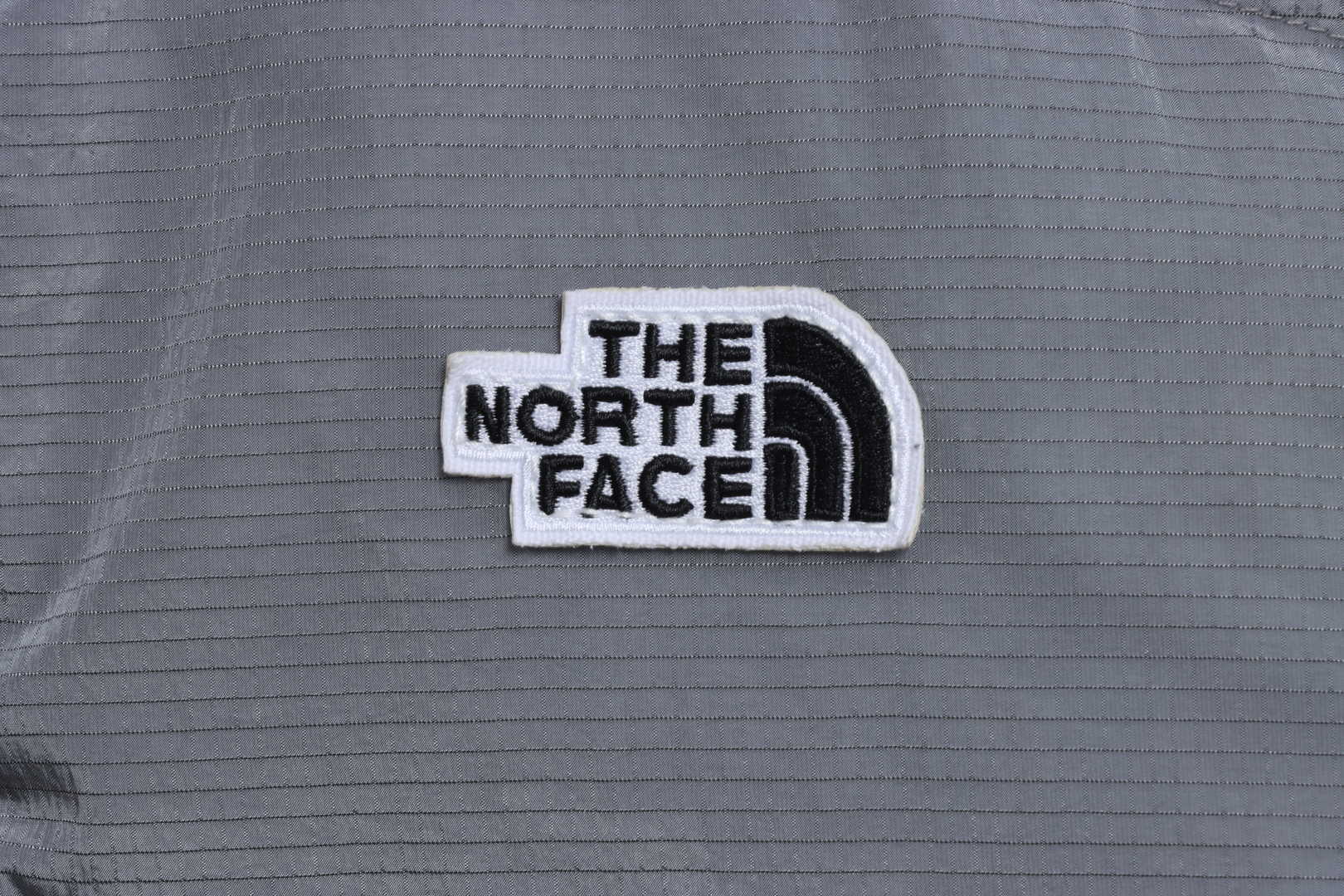 the n0*h F**e chest patch micro label down vest